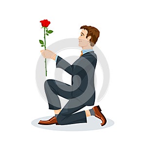 Man is kneeling with a flower in his hand. View from the side