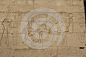 Man kneeling in front of the Theban triad in the mortuary temple of Ramesseum  in Egypt