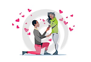 Man kneeling holding engagement ring proposing woman marry him happy valentines day concept african american couple in