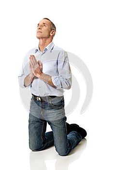 Man kneeling and praying to God