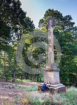 A man kneeling in reverance at Dead Mans` Plack,Harewood forest,Hampshire,United Kingdom