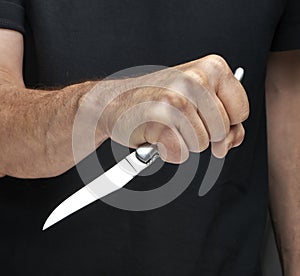 Man with a knife in a hand. Closeup