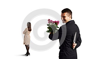 Man with knife standing behind woman