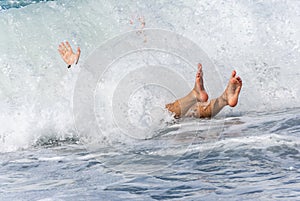 Man knocked down by a wave photo