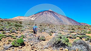 Man on La Canada de los Guancheros dry desert plain with view on volcano Pico del Teide, Mount El Teide National Park, Tenerife, photo