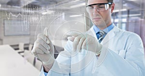 Man in lab coat with glass device and white graph with flare against blurry lab