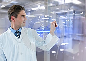 Man in lab coat holding up glass device against blue interface and blurry lab