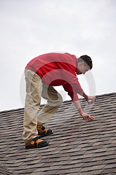 Man on Ladder on a roof photo