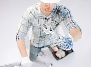 Man with ladder, toolkit and spanner