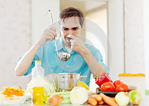 Man with ladle testing foul food