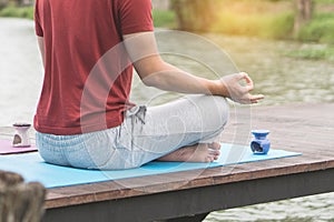 Man beside the lake and doing meditation in morning at lake