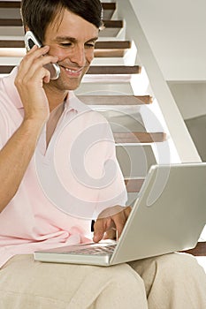 Man with laptop and cell phone