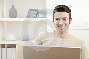 Man with laptop computer at home