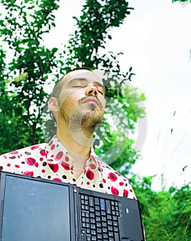 Man with laptop in garden