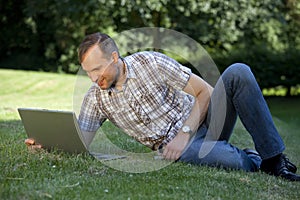 Man with laptop on the grass