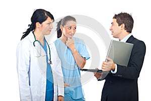 Man with laptop having conversation with doctors