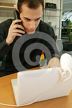 Man with laptop and mobile phone