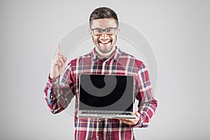 Man with laptop showing attention gesture