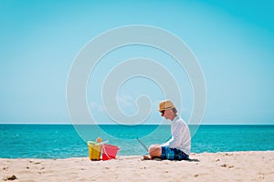 man with laptop on tropical beach vacation, family holiday at sea