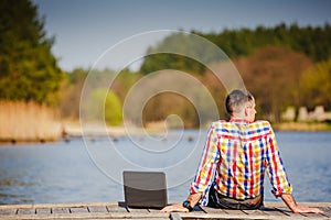 Man with laptop working outdoor