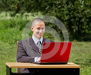 Man with laptop working outdoors