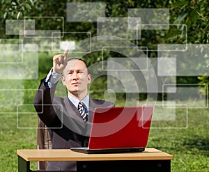 Man with laptop working outdoors