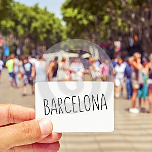 Man at Las Ramblas shows a signboard with the word Barcelona photo