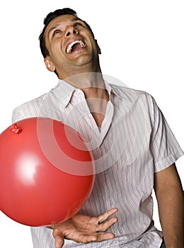 Man laughing and playing with baloon