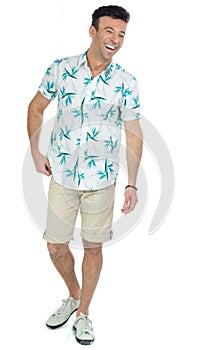 Man laughs spontaneously and amused. Handsome brazilian male wears floral shirt..