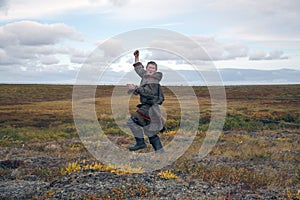 The man launches a kite in the tundra, for the first time in his life