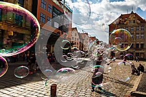 Man launches soap bubbles entertain tourists in the old city cen