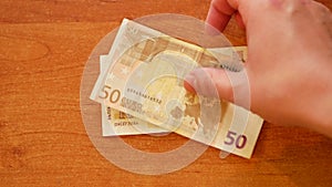 Man lay Bulgarian lev money and Euro on top