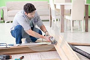 The man laying flooring at home