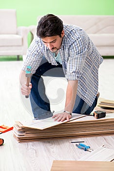 The man laying flooring at home