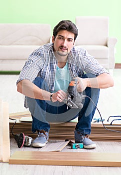 Man laying flooring at home