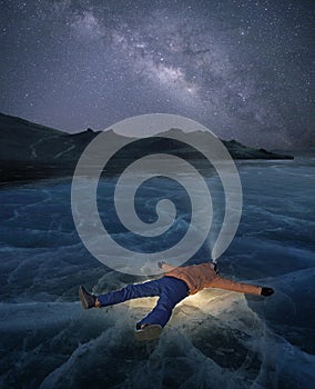 Man laying on a frozen lake