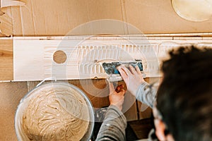 Man laying parquet flooring. Man installing hardwood flooring during house building