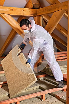 Man laying thermal insulation layer