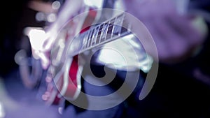 Man lead guitarist playing electrical guitar on concert stage on concert stage