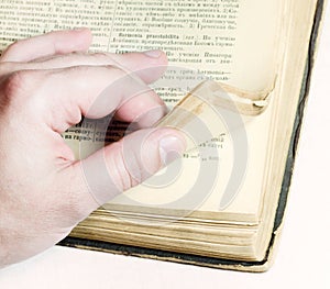 Man leafing through an old book
