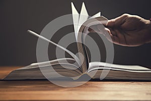 Man leafing through the pages of a book