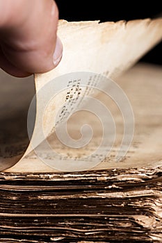 Man leafing through a thick old book