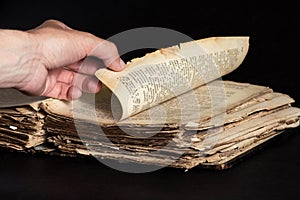 Man leafing through a thick old book