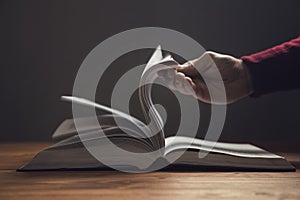 Man leafing through the pages of a book