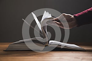 Man leafing through the pages of a book