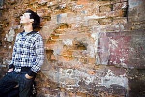 Man leaning against wall