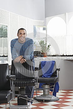 Man Leaning On Chair In Hair Salon