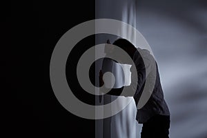 Man leaning head against wall