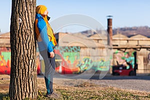 Man leaning on a tree and taking a rest from jogging