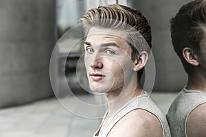 Man leans against reflecting window